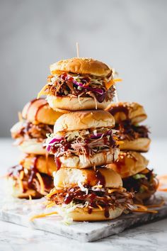 a stack of pulled pork sliders with cole slaw