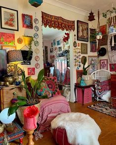 a living room filled with lots of furniture and pictures on the wall next to a doorway