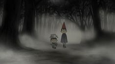 two people standing in the middle of a forest with trees and fog around them, one person wearing a gnome's hat