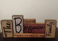 a couple of blocks that are on top of a wooden table with the words, best man and another block