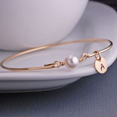 Gold Bangle Bracelet  White Pearl Bracelet by georgiedesigns Elegant Personalized Gift Bracelets, Personalized Classic Pearl Bracelet, Classic Personalized Pearl Bracelet, Elegant Round Bracelets For Personalized Gift, Elegant Personalized Round Pearl Bracelet, Elegant Charm Bracelet For Personalized Gift, Elegant Round Charm Bracelet For Personalized Gift, Elegant Personalized Adjustable Pearl Bracelet, Elegant Adjustable Personalized Pearl Bracelet