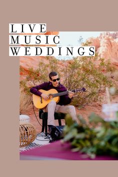 a man sitting on top of a chair holding a guitar in front of a desert landscape