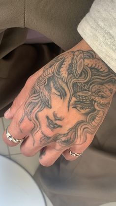 a person with a tattoo on their hand