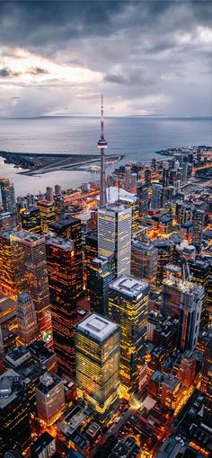 an aerial view of the city lights and skyscrapers at night in toronto, canada