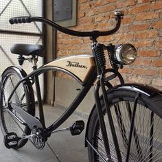 an old fashioned bicycle parked next to a brick wall