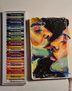 a couple kissing each other with colored crayons next to it