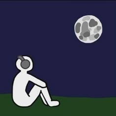 a man sitting on the ground in front of a full moon with his headphones up