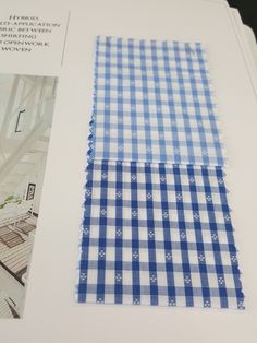 an open book with blue and white checkered fabric on it's cover, next to a photo of a kitchen