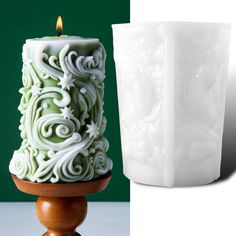 a white candle sitting on top of a wooden stand