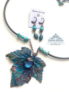 a necklace and earring set with leaves