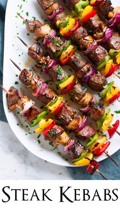 skewered meat and vegetables on a white plate