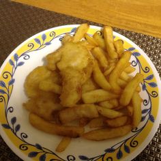 a plate with french fries on it sitting on a table