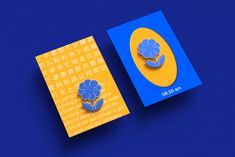 two blue and yellow brochures with flowers on them sitting next to each other