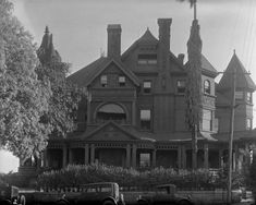 an old black and white photo of a large house