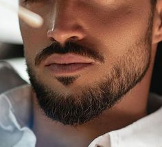 a close up of a man with a beard