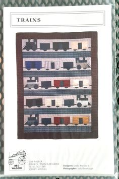 the train quilt is on display for sale