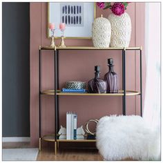 a shelf with vases and books on it