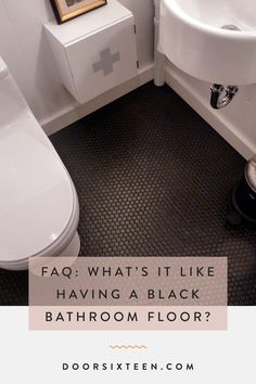 a bathroom with a sink, toilet and bathtub in it that says faq what's it like having a black bathroom floor?