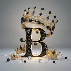 the letter b is made up of black and gold jewels, with a crown on top