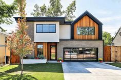 a modern house with two garages in the front yard