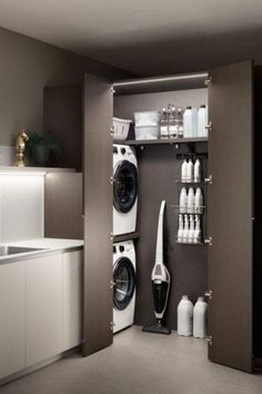 a washer and dryer in a small room with white appliances on the wall