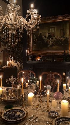 a dining room table is set with candles and plates