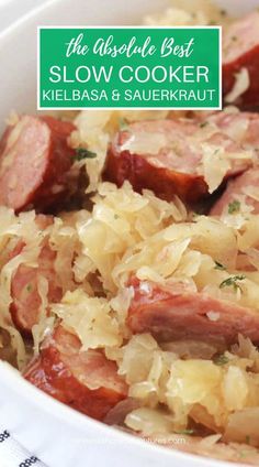 a close up of a bowl of food with cabbage and meat in it on a table