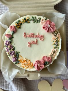 a birthday cake decorated with flowers and the words happy birthday girl