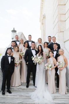 a group of people in formal wear standing on steps