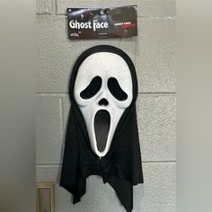 a ghost face mask hanging on the wall