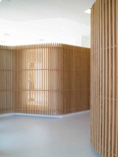 an empty room with wooden partitions on the wall