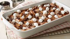 a casserole dish with marshmallows and chocolate