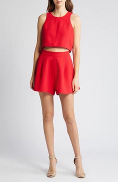 This two-piece romper made from pebbled crepe comes with a cropped tank and pleated high-waist shorts you can mix and match with other pieces in your wardrobe. 16" length; 3" inseam; 35" leg opening; 15" front rise; 17 1/2" back rise (size 8) Top has hidden back-zip closure; jewel neck; sleeveless Shorts have hidden back-zip closure Lined top 99% polyamide, 1% elastane Dry clean Made in the USA of imported fabric Women's Clothing Chic Two-piece Bottoms For Date Night, Chic Fitted Cropped Shorts, Chic Structured Summer Bottoms, Two-piece Short Bottoms For Spring, Chic Short Crop Top For Day Out, Spring Two-piece Short Bottoms, Summer Party Crop Top, Cropped Bottoms For Summer Night Out, Chic Cropped Summer Shorts