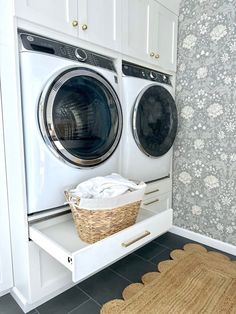 a washer and dryer in a room with floral wallpaper on the walls