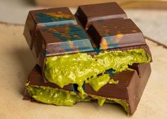 there is a chocolate bar with green icing on it and some pieces cut in half