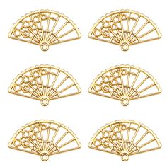 four gold fan shaped charms on a white background