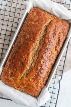 a loaf of banana bread sitting on top of a cooling rack