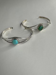 Sterling silver cuff bracelet with dainty rope detail. Set with a single round turquoise. This bracelet is adjustable so one size should fit most. Cheap Adjustable Blue Cuff Bracelet, Cheap Turquoise Cuff Bracelet As Gift, Cheap Turquoise Bangle Bracelet, Elegant Adjustable Turquoise Sterling Silver Bracelet, Sterling Silver Turquoise Bracelet, Round Turquoise Sterling Silver Cuff Bracelet, Adjustable Round Turquoise Bangle, Silver Turquoise Jewelry, Turquoise Bracelet Cuff