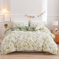 a bed with green and white comforters in a room