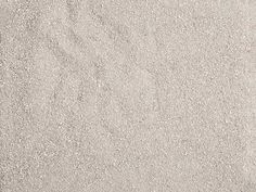 an orange and white frisbee laying in the sand