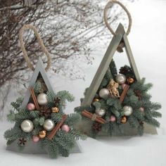 two small christmas trees with ornaments on them