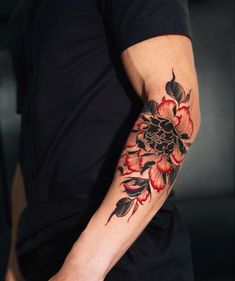 a man with a flower tattoo on his arm