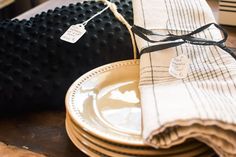 a stack of plates and napkins on a table