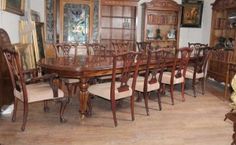 a large wooden dining table surrounded by chairs