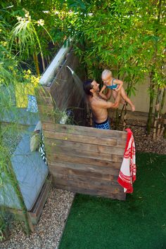 a man holding a baby in his backyard