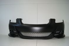 the front end of a black car with grills on it's sides and bumper