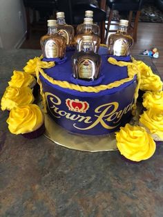 a cake decorated with liquor bottles and yellow flowers