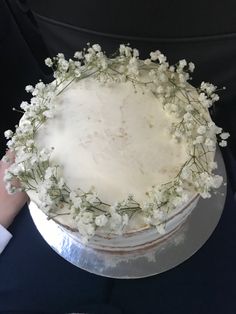 there is a cake with white frosting and flowers on it