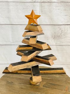 a wooden christmas tree made out of pieces of wood