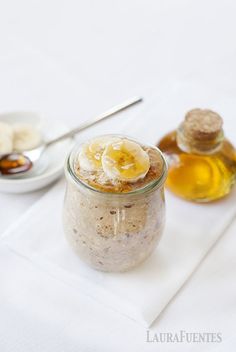 a jar filled with oatmeal sitting on top of a white table cloth